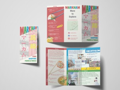A promotional brochure layout for Markham with three visible panels, designed to showcase various local attractions. The brochure features sections for dining, shopping, and parks & trails, each with colorful backgrounds and images. It highlights several restaurants with their addresses and some images of food. There's also a shopping section with a prominent image of Decathlon at Markham Town Square and other shopping destinations. The parks & trails section suggests outdoor activities for burning off calories from the meals. The brochure includes web and social media links for further information. The design is vibrant and informative, aiming to attract visitors to explore Markham's amenities.